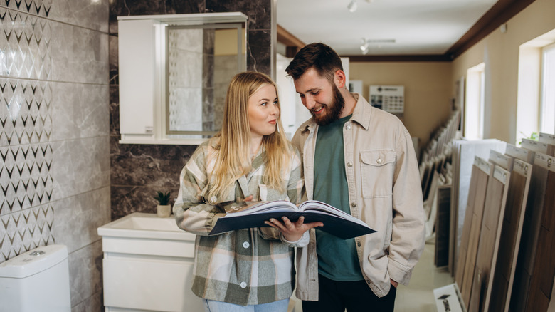 A couple looks at options for their bathroom in a showroom