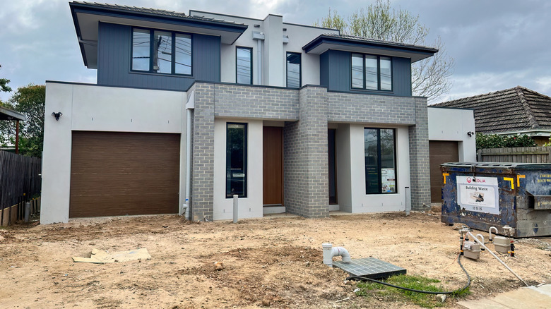 A home with a driveway that lacks a surface
