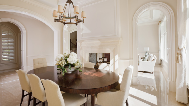 formal walled in dining room with arched doorways and cream colored moldings