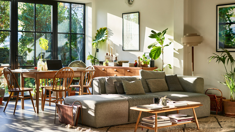 open floor plan dining room and living room delineated by furniture and rug
