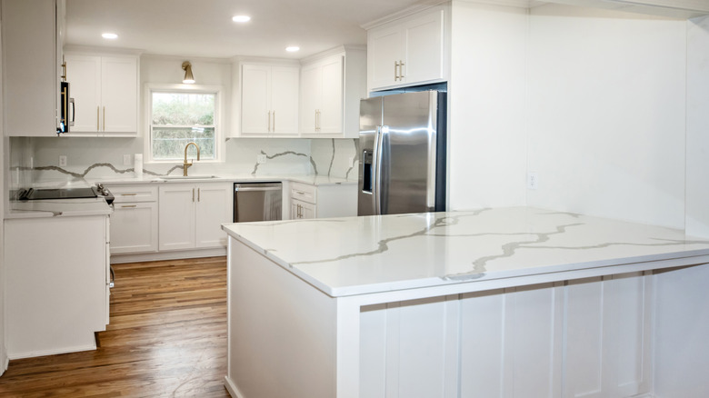 Modern kitchen with white cabinets and marble-look quartz countertops