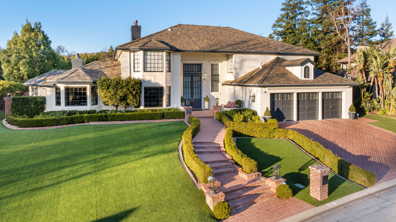 House with a manicured front lawn and hedges