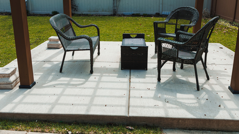Concrete patio with black furniture