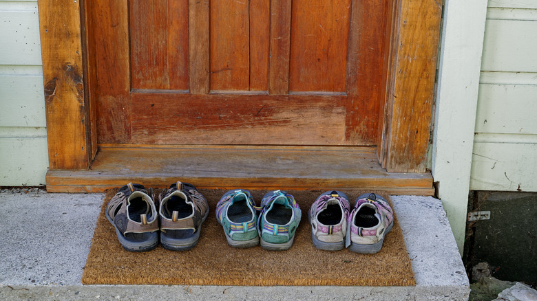 pairs of shoes on front doorstep