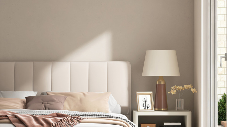 A light-filled bedroom is painted in an appealing soft off-white color