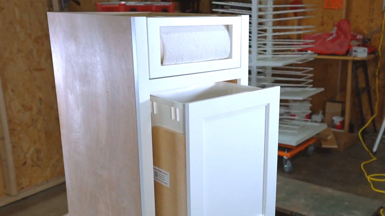 A commercially produced kitchen cabinet with a paper towel drawer