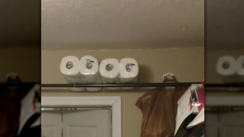 A tension rod over the pantry door creates storage space for paper towel rolls