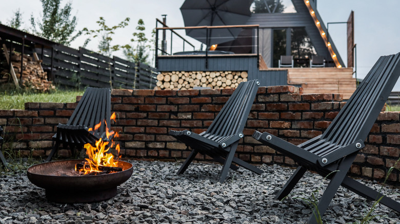 Gravel patio with rustic metal fire pit