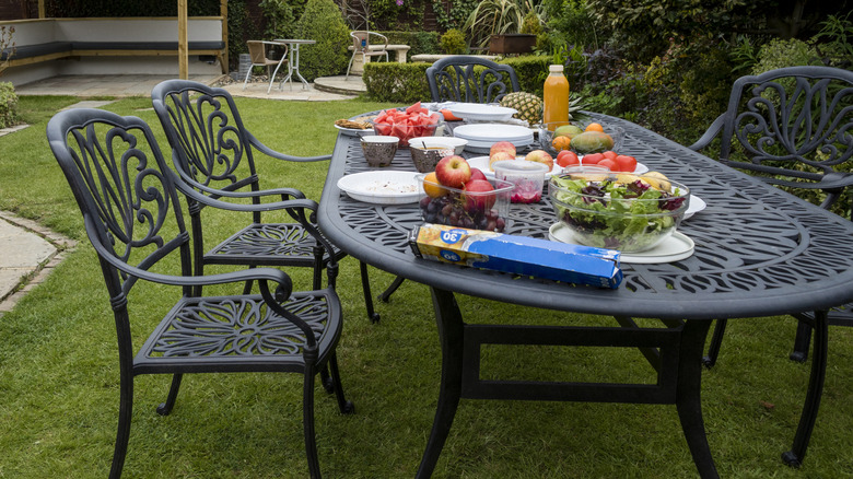 Family gathering around patio table for lunch