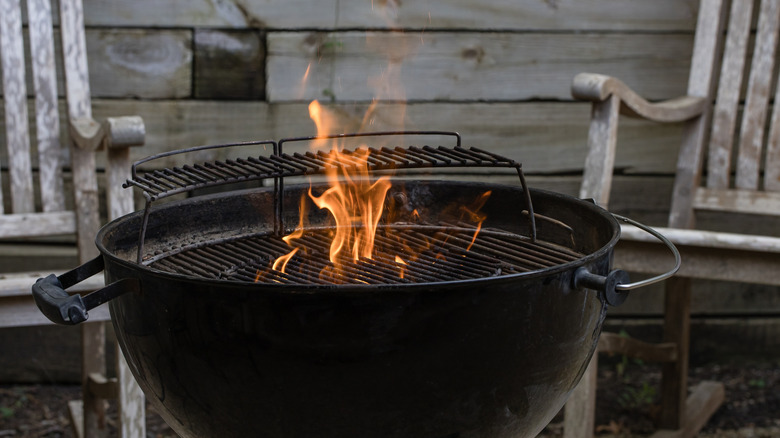 Charcoal kettle grill with flames