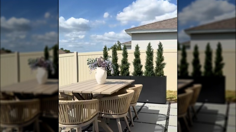 Patio with Amazon planters and artificial trees creating a privacy screen