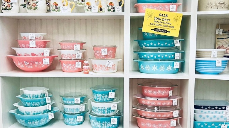 A variety of pink and blue Pyrex dishes in a store