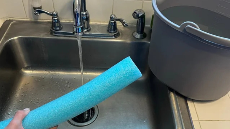a sink, bucket and pool noodle