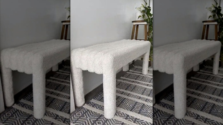 DIY white boucle-style pool noodle bench on top of a chic geometric carpet.