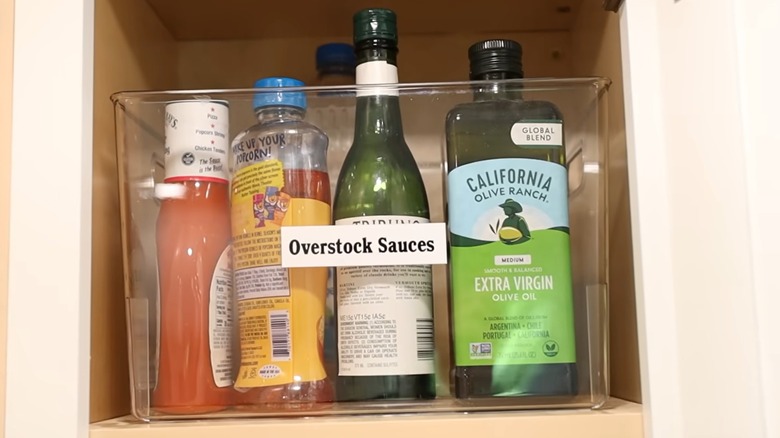 Overstock storage system for sauces in a bin
