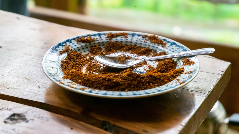 Used coffee grounds on a plate