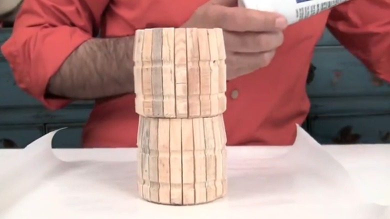 Glass jar covered in wooden clothespins for DIY vase decor