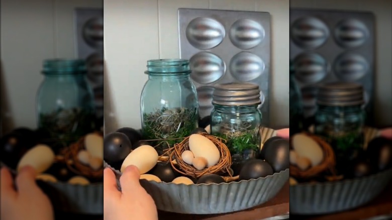Rustic spring and Easter DIY decor made with blue-tinted vintage jars and faux eggs