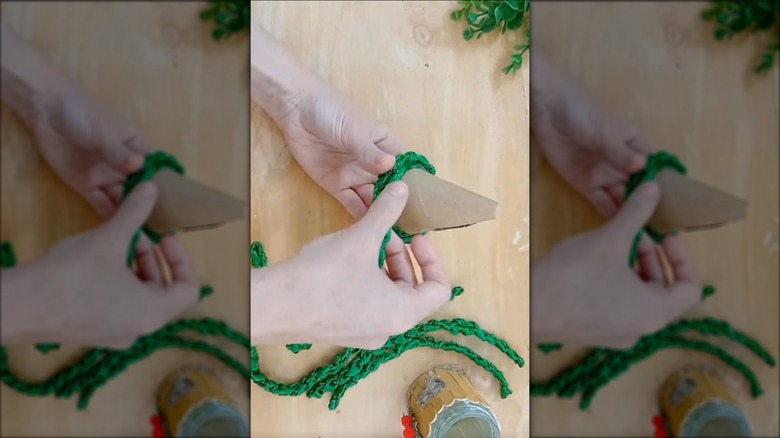 Woman designing Christmas tree using household materials and an upcycled glass jar