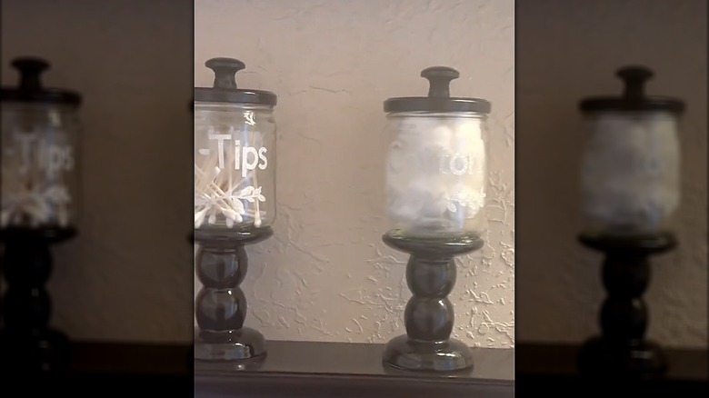 DIY pedestal holders with labeled bathroom essentials made from jam jars and candle pedestals