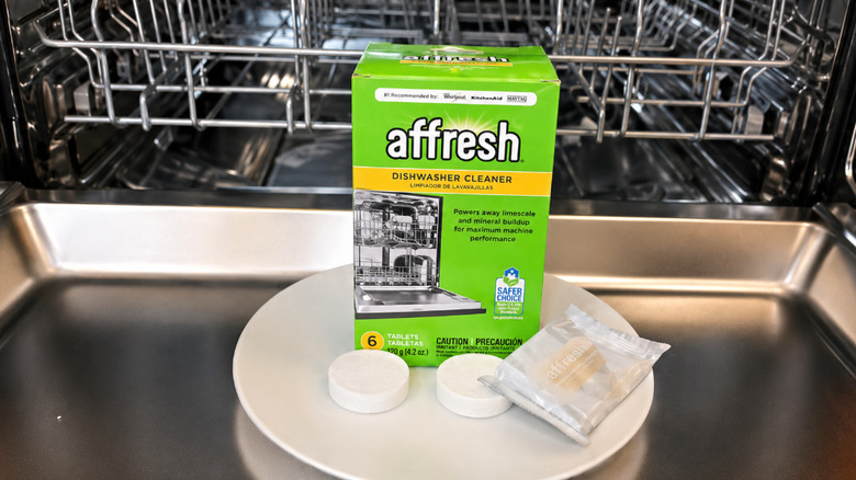 Affresh tablets sitting on the inside of a dishwasher door