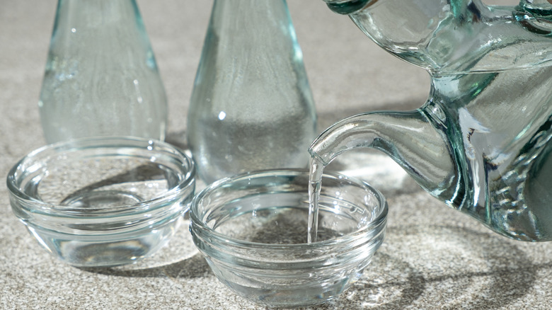 pouring white vinegar into a bowl