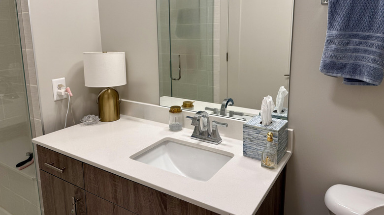 A neatly-arranged white quartz countertop in a bathroom