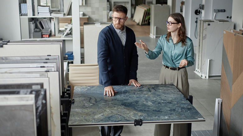 Two people discussing countertop materials in a store