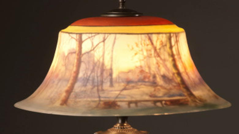 Antique Pairpoint lamp with shade reverse-painted with a woodland scene.