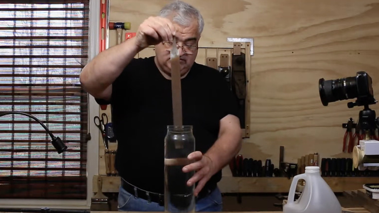 Homeowner cleaning rusty file with vinegar