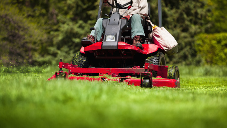Person riding a lawn mower