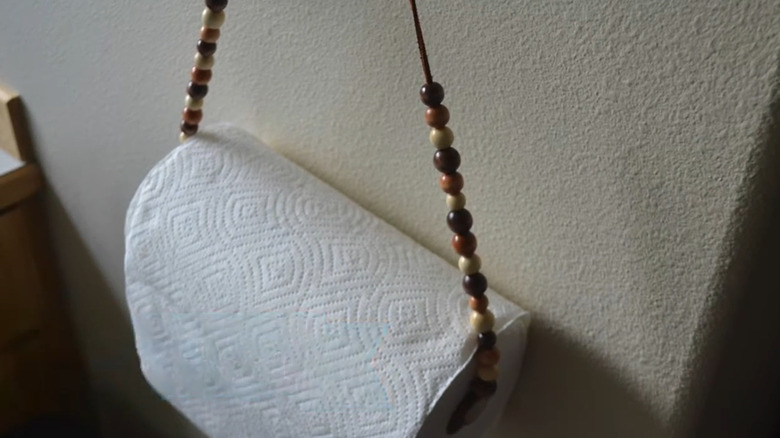 DIY paper towel holder with beads along the sides