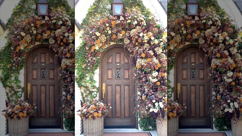 Brown front door with autumnal faux floral arch