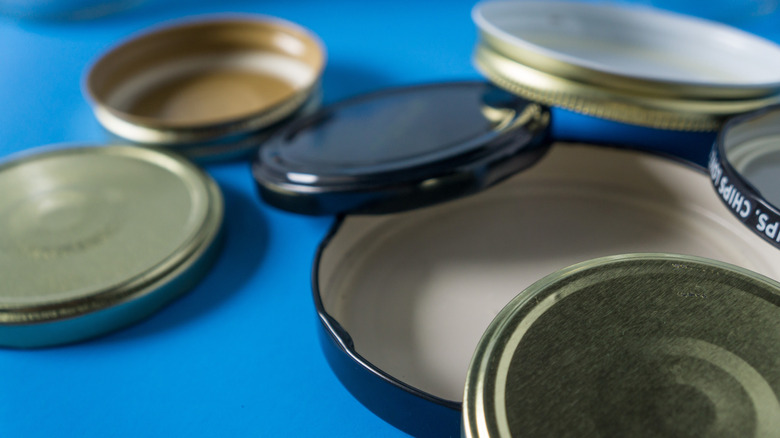 Metal jar lids on blue background