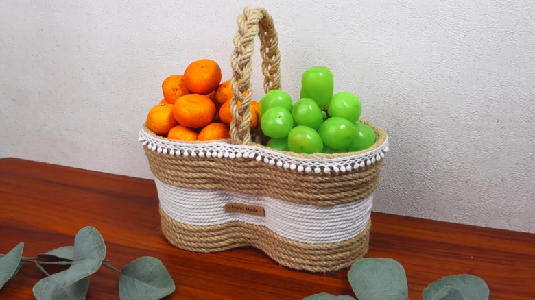 Homemade basket crafted with yogurt tubs and string