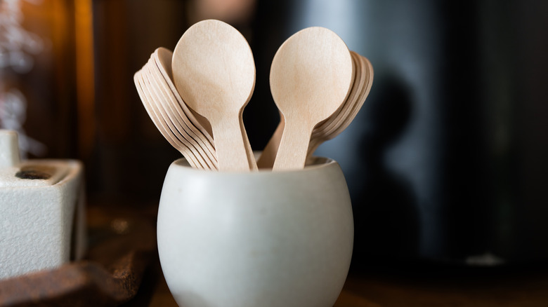 bowl of disposable bamboo wood spoons