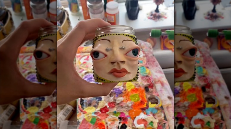 hand holding unique sculpture jar