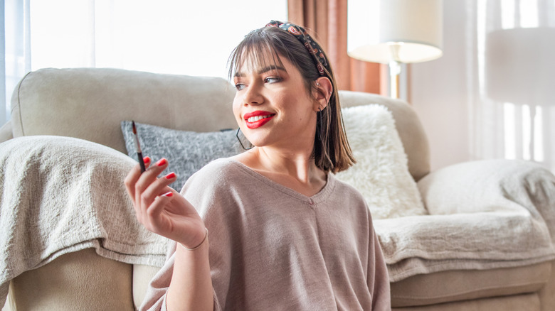 Person holding paintbrush smile smiling