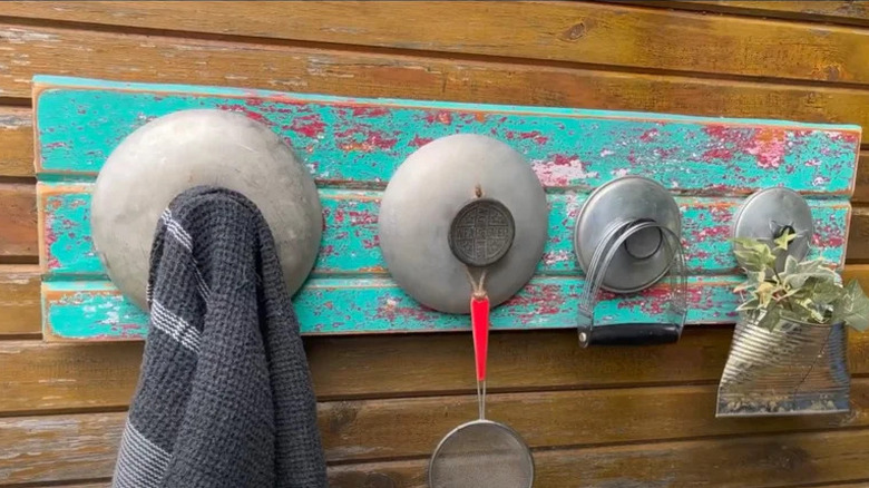 Towel hanger made from pot lids and a door