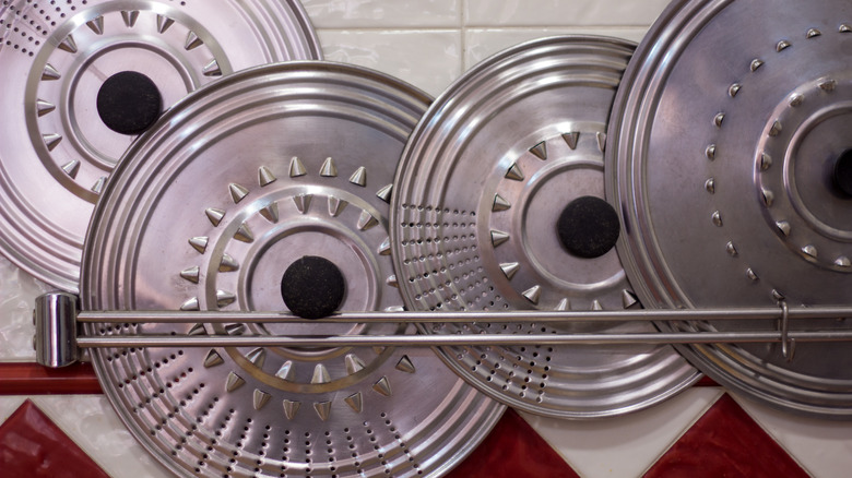 Rustic steel pot lids in a kitchen