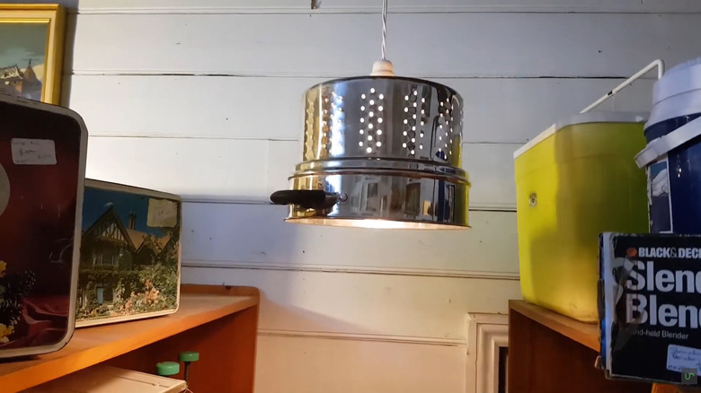 a pendant light made from colander insert from a stockpot