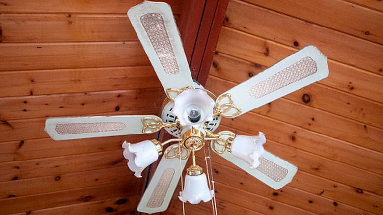 Retro white ceiling fan in wood-beam ceiling.
