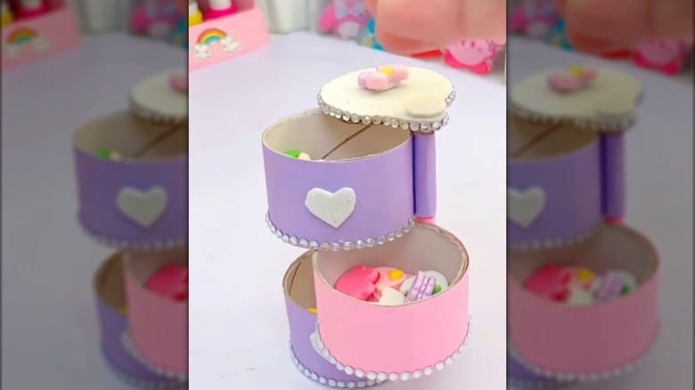 Purple and pink storage tower with sliding compartments made from toilet paper tubes