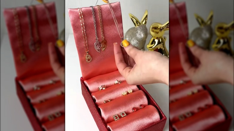 DIY jewelry holder with toilet paper tube slots covered in fabric