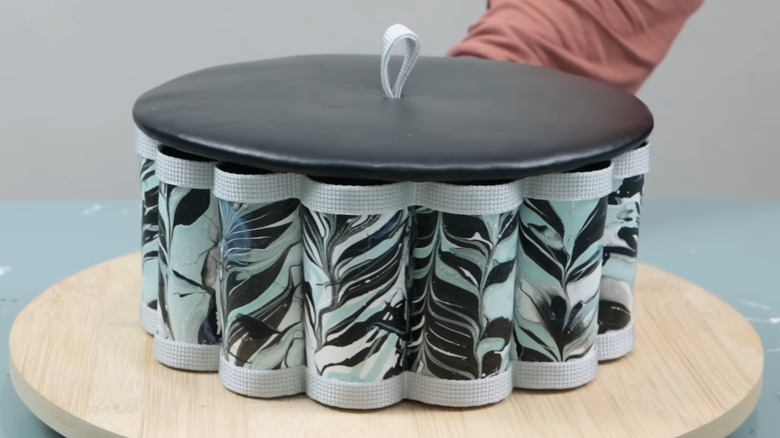 Scalloped-edge storage container made from toilet paper tubes with a lid