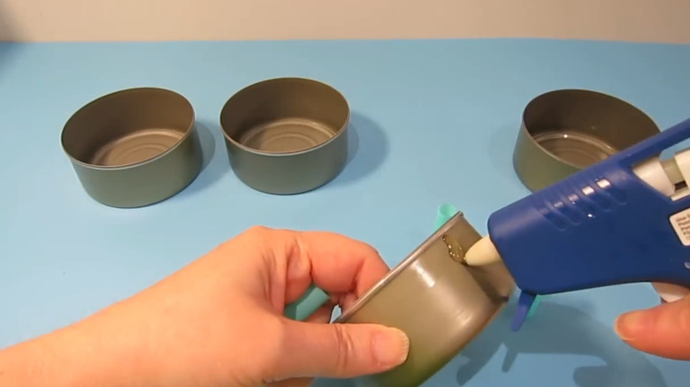 Hand gluing tuna cans
