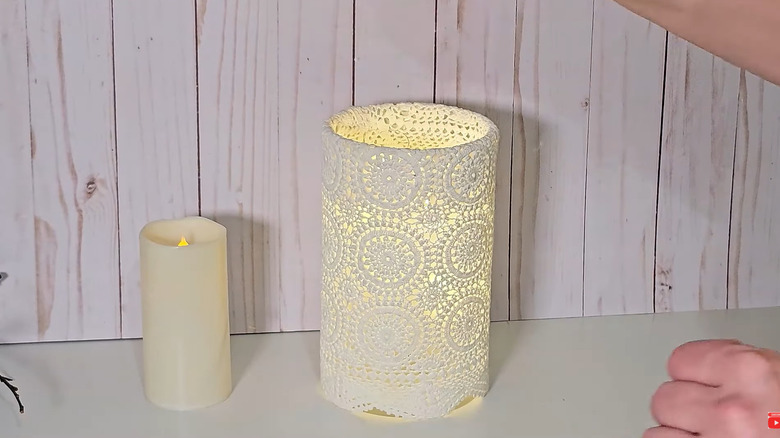 Lace doily wrapped around electronic tealight candle for vintage effect