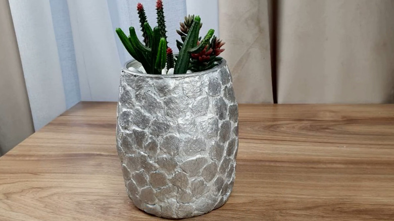 A planter of faux succulents made of decorated yogurt containers