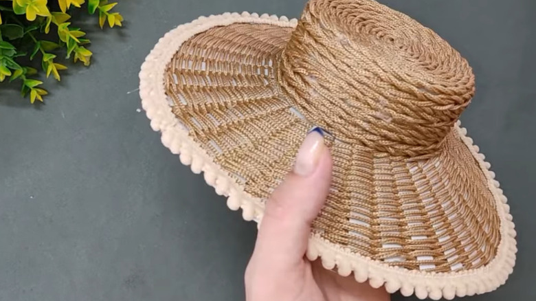 A woven hat made from a yogurt container