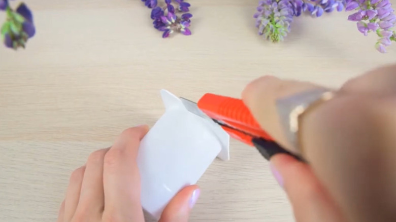 Person eating yogurt out of a small yogurt cup